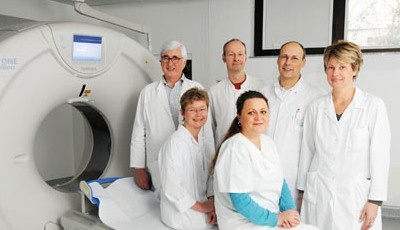 Prof. Dr. Dieter Beyer (links hinten) und sein Team vor dem CT AquilionONE